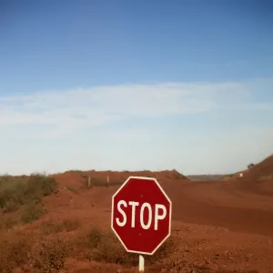 A stop sign at an intersection in a desert