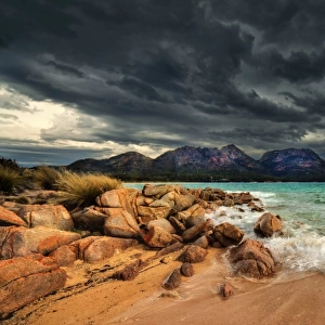 Storm clouds over mountains and beach