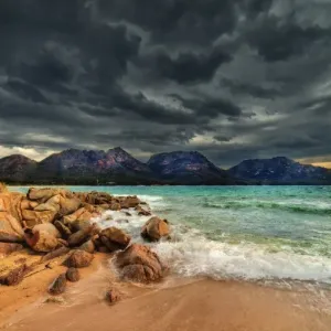 Storm clouds over mountains and beach