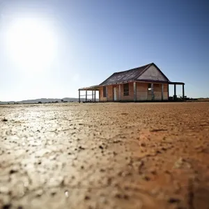 sun behind an outback shed