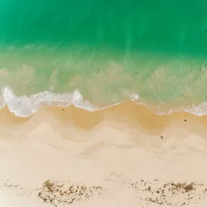 Turquoise ocean on sandy beach aerial view