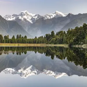 View of snow-covered Mount Cook and Mount Tasman, reflection in Lake Matheson View of snow-covered Mount Cook and Mount Tasman, reflection in Lake Matheson