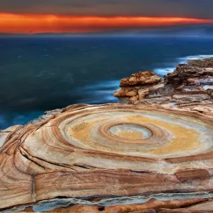 Weathered rocky shoreline at sunset