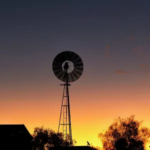Windmill out in the country at sunset