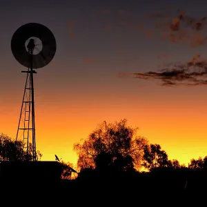 Windmill out in the country at sunset