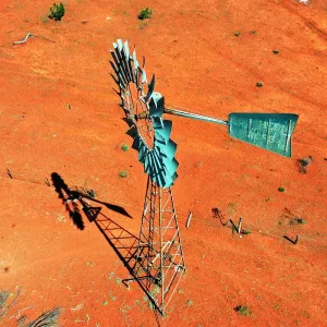 Windmill, water windpump on farm with dry red dirt field, Australia, aerial view Windmill, water windpump on farm with dry red dirt field, Australia, aerial view