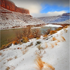 A winter mantle of snow lies along the banks of the Colorado river near Moab in Utah