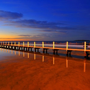 A wooden bridge before sunrise