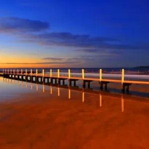 A wooden bridge before sunrise