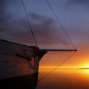 Wooden sailing boat and sunrise
