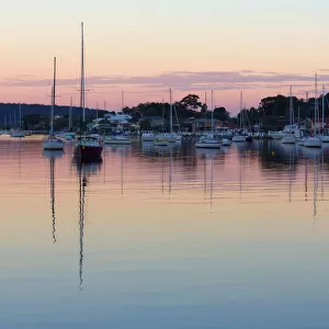 Yachts at sunset with reflection