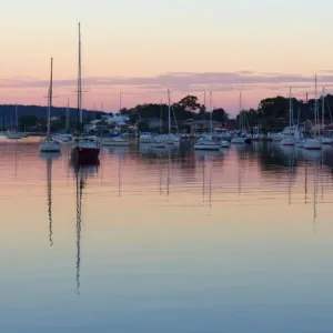 Yachts at sunset with reflection