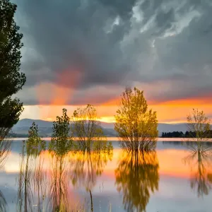 Yellow, Orange, Pink, and Gray Clouds at Sunset over Lake Jindabyne, Australia Yellow, Orange, Pink, and Gray Clouds at Sunset over Lake Jindabyne, Australia