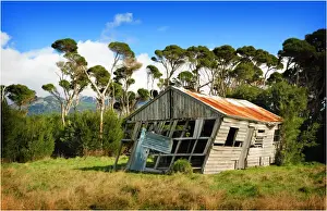 Abandoned and derelict old machinery shed in the rural farmland of Flinders Island, Bass Strait, Tasmania