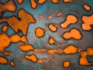 Aerial image showing bizarre industrial substance floating in a tailing pond, Australia