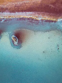 Aerial perspective at the edge of a vibrant coloured salt pool, Western Australia