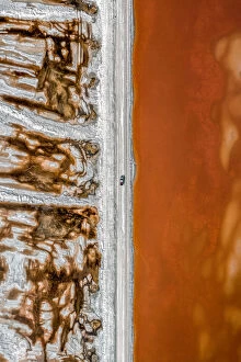 Images Dated 4th March 2020: Aerial shot of an dirt track and a truck alongside vibrant coloured salt ponds