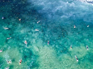 Ocean Wave Aerials Collection: Aerial View over blue and green clear ocean waters with surfers