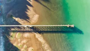 Prints of Aerial view of Cornwallis Wharf, situated in waitakere ranges, with the gradient of rocks, sand and water New Zealand Prints: Aerial view of Cornwallis Wharf, Auckland New Zealand