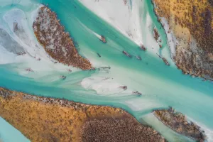 Prints of Overhead view of Makarora river flowing into Lake Wanaka, Otago, South Island New Zealand New Zealand Prints: Aerial view of river flowing with turquoise colors
