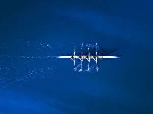 Felix Cesare Collection: Aerial view of a rowing boat surrounded by classic blue water