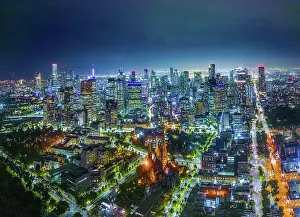 Aerial view Scene of Central Business District of Melbourne City with Modern Office Building and St Patrick's Cathedral at night, Melbourne