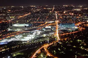 Building Exterior Prints: Aerial view of sports venues in Melbourne illuminated at night