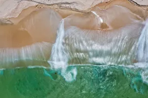 Aerial view of turquoise water crashing onto a sandy beach - Long Exposure Aerial view of turquoise water crashing onto a sandy beach - Long Exposure