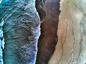 Aerial view of waves breaking on beach