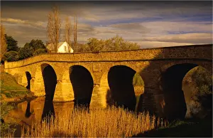 Colonialism Prints: Afternoon light sweeps over the historic convict built stone bridge at Richmond in southern Tasmania