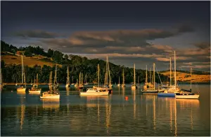 Afternoon light sweeps across the moored boats in the protected and picturesque bay at Kettering, southern Tasmania