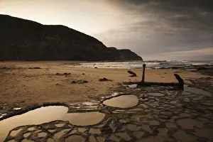 The anchor of the Marie Gabrielle shipwreck and rock pool reflections on Wreck Beach