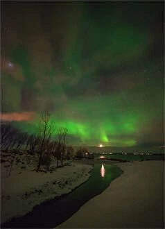 Images Dated 5th March 2014: Aurora Borealis lights up the sky behind the city of Akureyri, Iceland