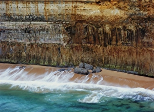 Australia, Victoria, ocean waves and beach below cliff, elevated view Australia, Victoria, ocean waves and beach below cliff, elevated view