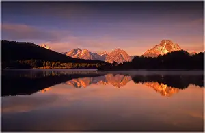 Jackson Lake Prints: A beautiful coloured dawn casts its glow over Jackson lake in the Grand Tetons, Wyoming
