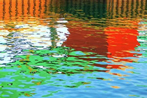 John White Photos Collection: Blue, green, red, orange and brown colours reflected in the sea at the commercial dock at the Port