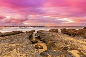 Prints of Bright and vibrant colored Sunset over the ocean with rock formations, Gold Coast, Australia Queensland (QLD) Prints: Bright and vibrant colored Sunset over the ocean with rock formations