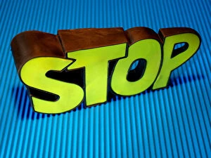 Abstracts Collection: Bright yellow stop sign on blue background