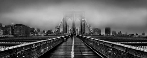 Brooklyn Bridge at dusk under a cloud of fog in black and white Brooklyn Bridge at dusk under a cloud of fog in black and white