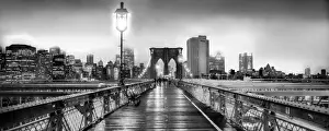 Brooklyn Bridge and Manhattan skyline under heavy fog in black and white