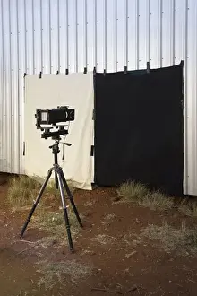 Preparation Prints: A camera and back drop set up outdoors