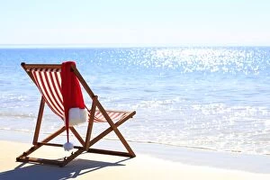 Images Dated 14th July 2014: Christmas santa hat on a beach chair. Australia
