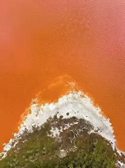 Composed drone shot at the edge of an orange coloured salt lake, South Australia, Australia