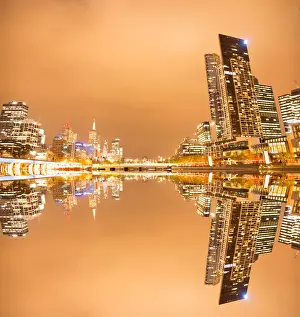 Composite image of city river and office and apartment buildings at dusk