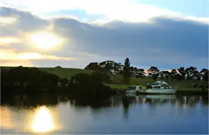 Dawn breaking though the clouds on the Nicholson river, east Gippsland, Victoria