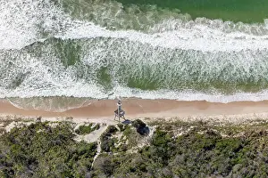 Desolate section of coast with nautical warning tower in foreground