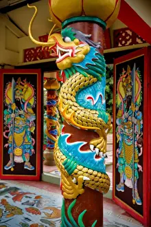 Vibrant Color Prints: A Dragon Carving on a Pillar in Wat Hainan Temple Nathon