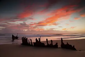 A dramatic sunrise on Dicky Beach with the wreck of the SS Dicky in the foreground