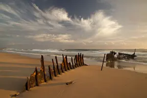 Ship Wrecks Around Australia Prints: A dramatic sunrise on Dicky Beach with the wreck of the SS Dicky in the foreground