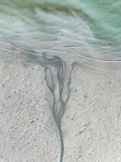 Aerial Beach Photography Prints: Drone image looking down on a stream of water flowing into Roebuck Bay at low tide